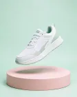 An unbranded sneaker floating over a pastel podium