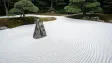 A minimalist zen garden with raked gravel ripples — AI-generated example render